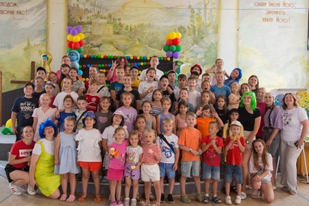 Group of children playfully celebrating summer camp
