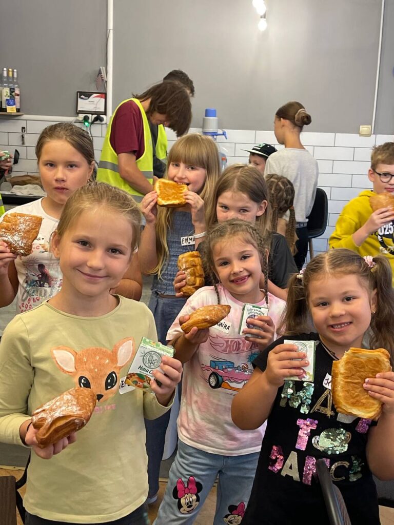 Little girls enjoying baked goods at summer camp